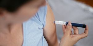 injection with insulin pen stock photo