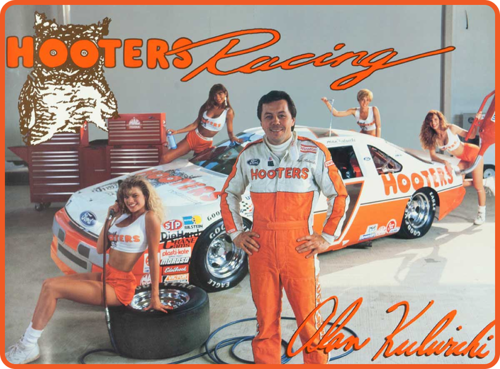 a photo of hooters racing with a race car, driver and hooters girls in the image