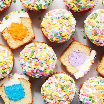 vanilla cupcakes with a colorful filling and sprinkles