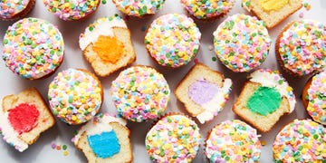 vanilla cupcakes with a colorful filling and sprinkles