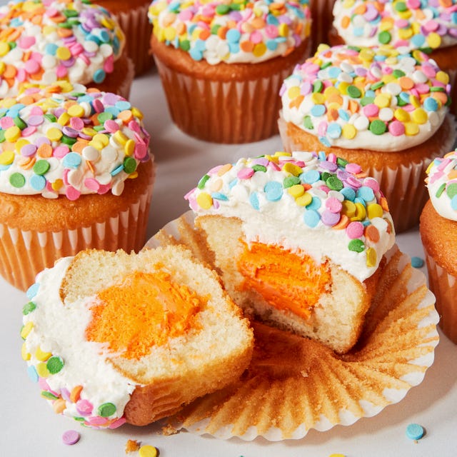 vanilla cupcakes with a colorful filling and sprinkles