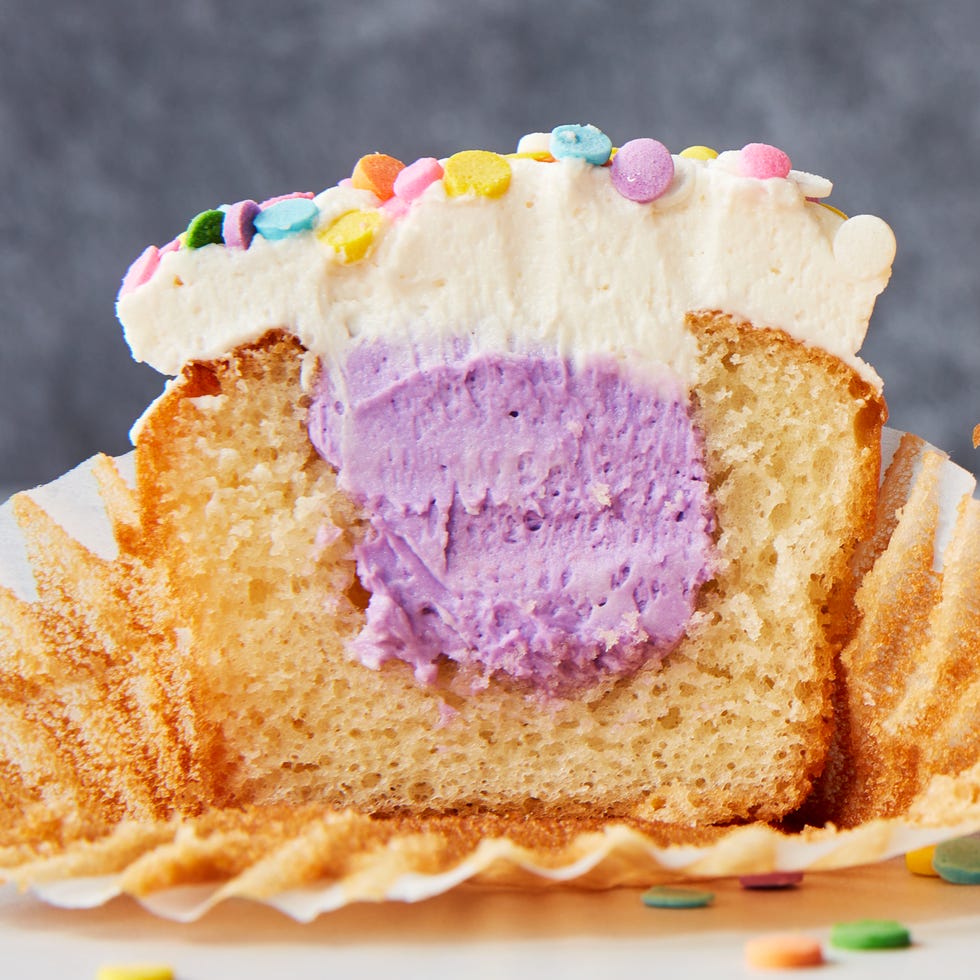 vanilla cupcakes with a colorful filling and sprinkles