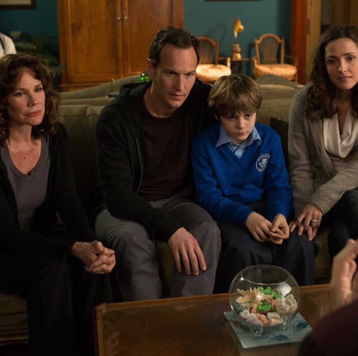 josh, dalton and renai sit on a couch together, listening with concern, in a scene from insidious chapter 2