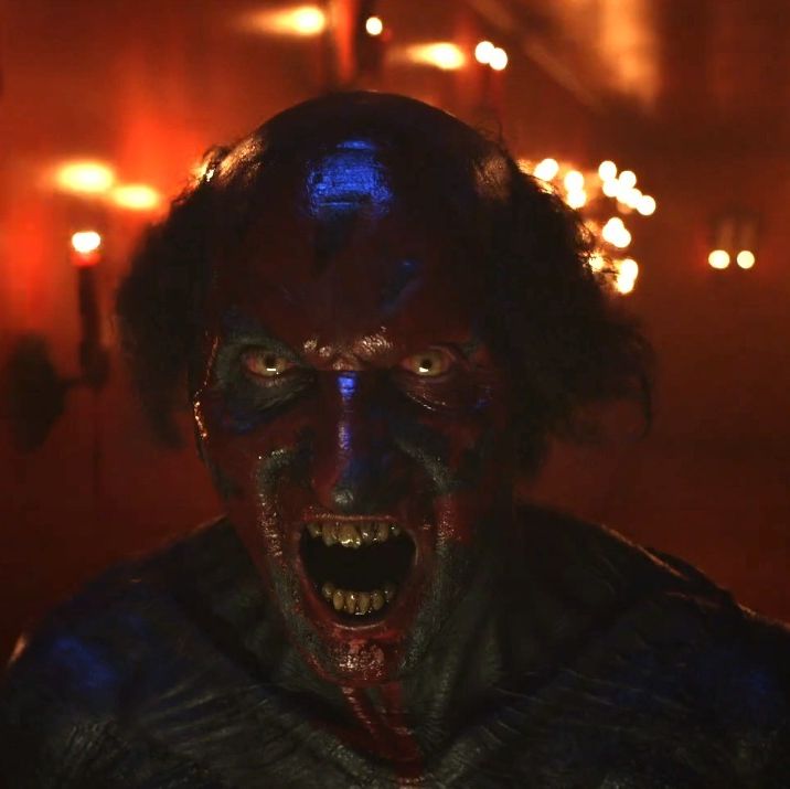 a red faced demon screams in a scene from insidious the red door