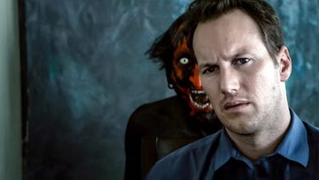 a red faced demon stands behind a man in a scene from the insidious franchise