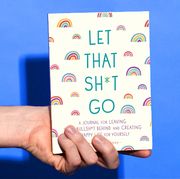 hand holding let that shit go journal