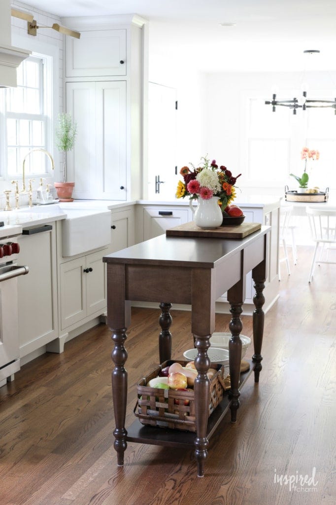 Island kitchen ideas like an all-white kitchen with L-shaped cabinets