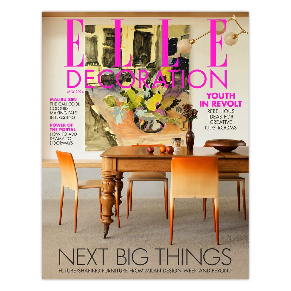 a table with chairs and a table with a flower arrangement on it