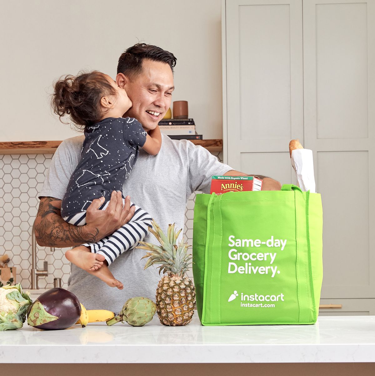 instacart delivery bag with father and daughter unloading groceries