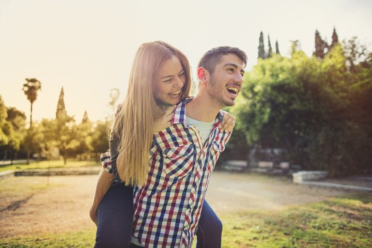 woman riding piggy back on a man