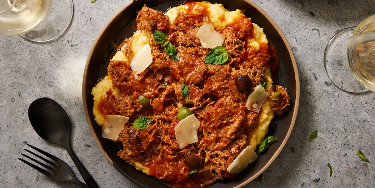 instant pot pork puttanesca with olives, capers, and shaved cheese over polenta