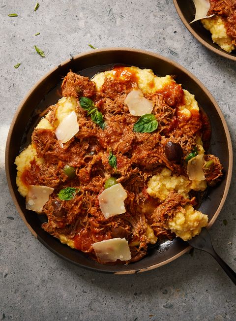 instant pot pork puttanesca with olives, capers, and shaved cheese over polenta