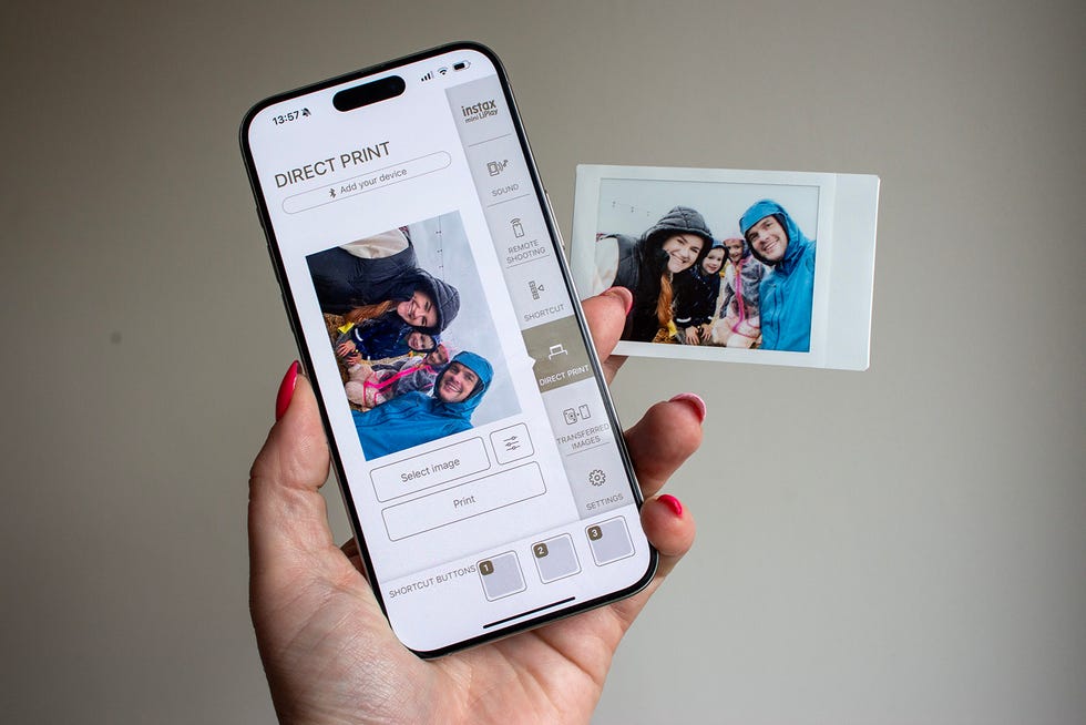 a smartphone displaying a direct print interface alongside a printed photo