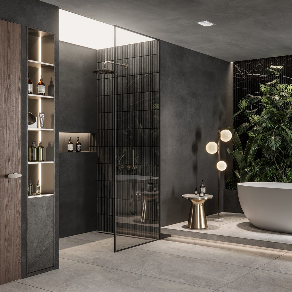 interior of a luxurious bathroom with shower area and bathtub, as well as live greenery and a globular lighting fixture