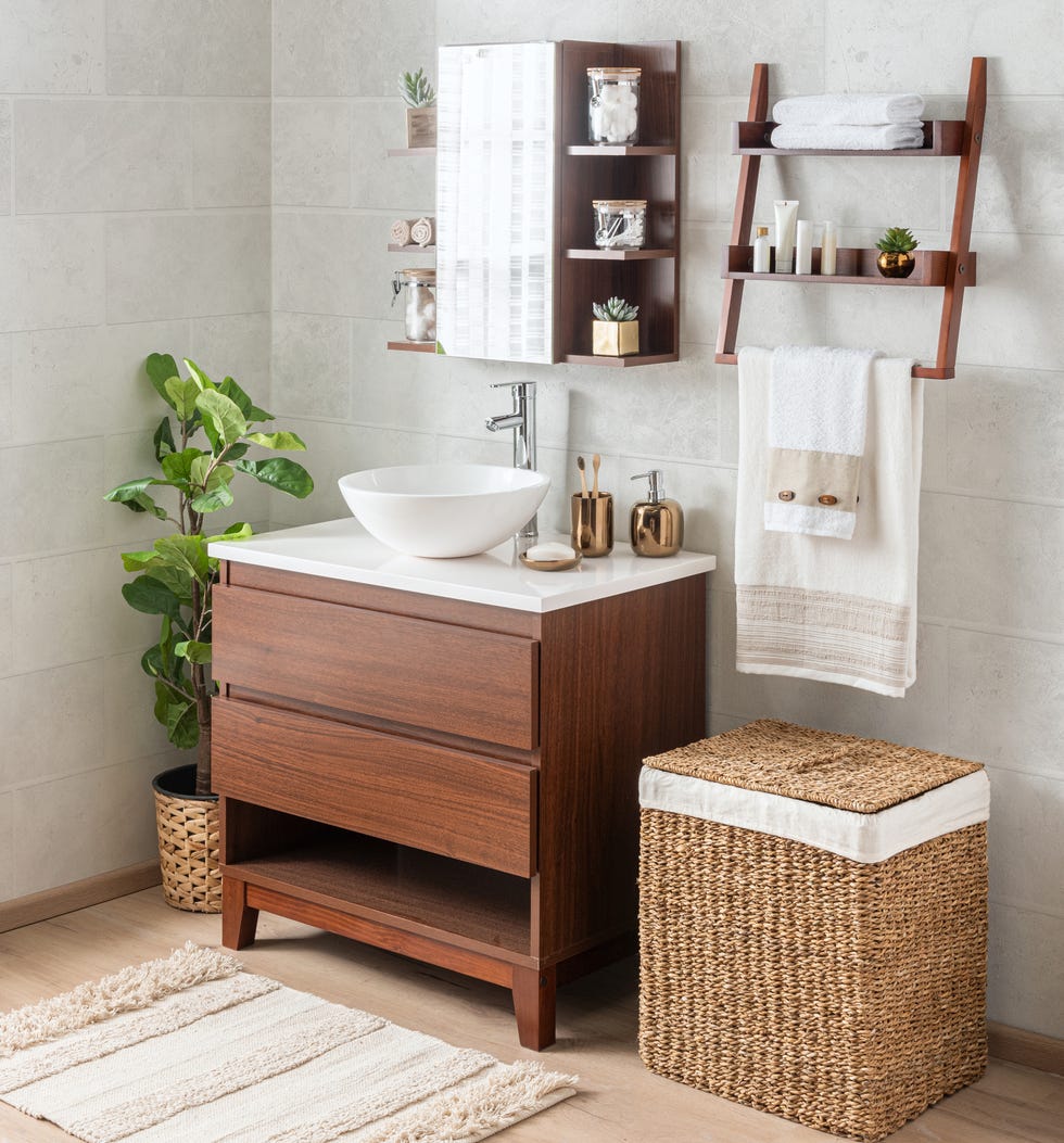 interior of the bathroom with a mid century modern bathroom vanity featuring a ceramic washbasin and wicker baskets