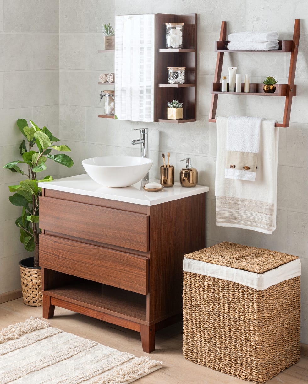 Interior of the bathroom interior of the bathroom with a mid century modern bathroom vanity featuring a ceramic washbasin and wicker baskets