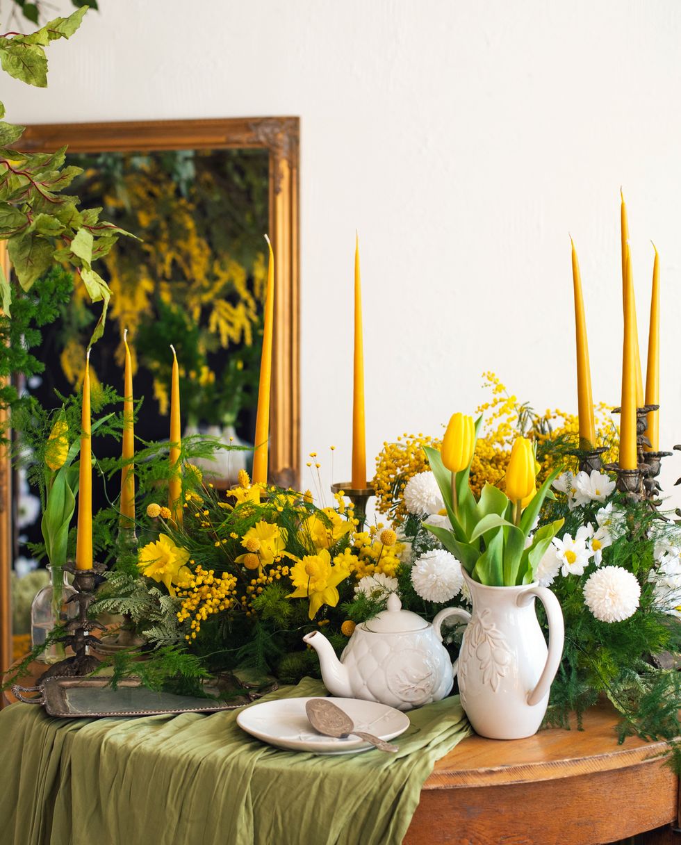 interior with floral decor table setting in spring style with mimosa and tulips spring easter mothers day women's day