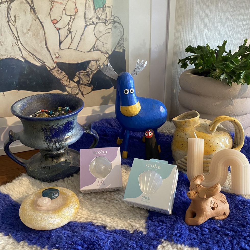 a blue bird statue next to a tea set and a teapot