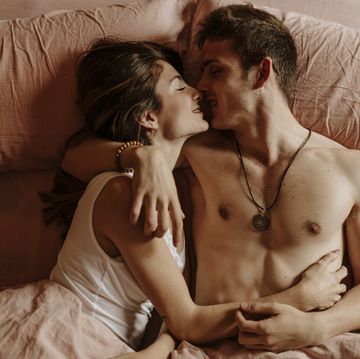 intimate young couple lying in bed