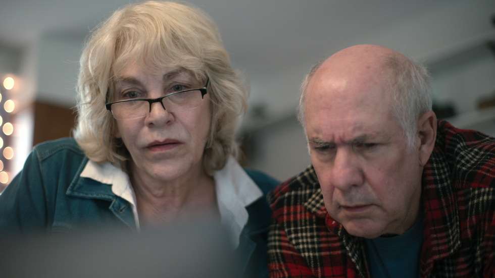 cathy and ed terkanian look at a computer together