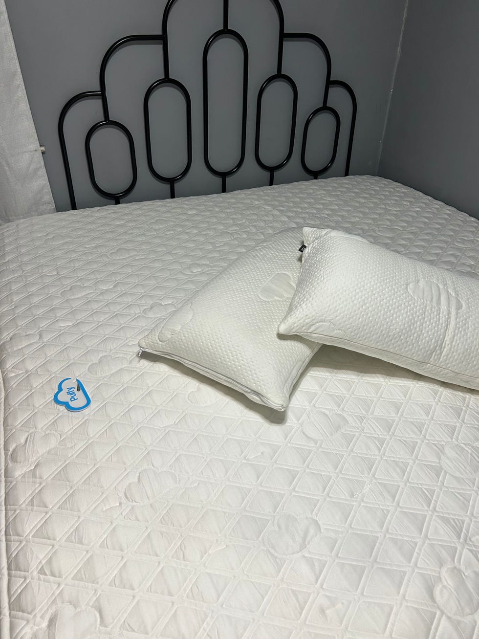 two pillows from puffy on a puffy mattress in a bedroom
