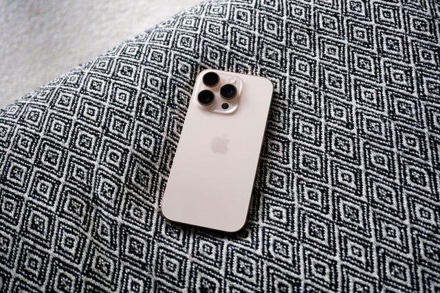apple iphone 16 pro smartphone resting on a patterned fabric