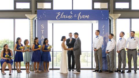 Iram Leon and Elaine Chung marry underneath a starting line. 