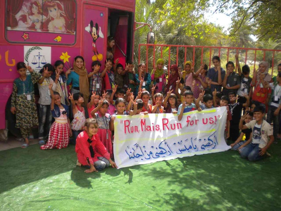 iraqi children foundation kids holding up sign of support for mais