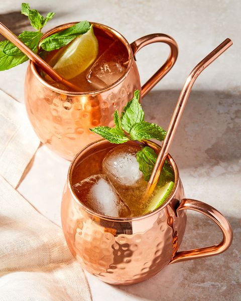 two irish mules garnished with mint in copper mugs