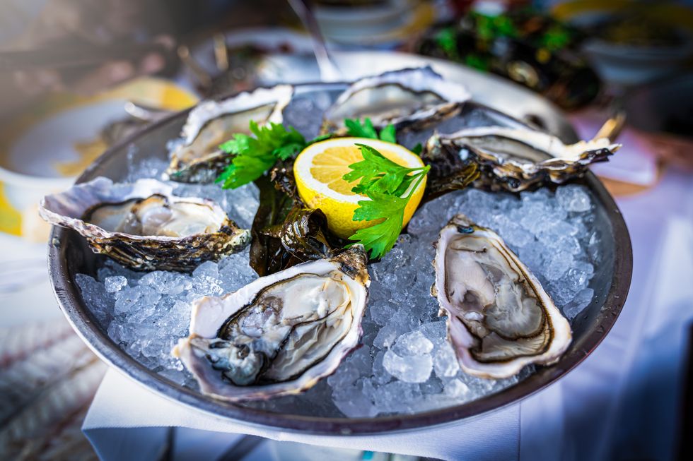 iron rich foods half dozen fresh oysters are served with lemon in bowl with plenty of ice