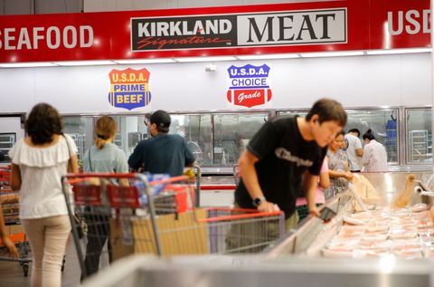 is costco open on labor day customers with shopping carts looking at the seafood and meat cases at costco