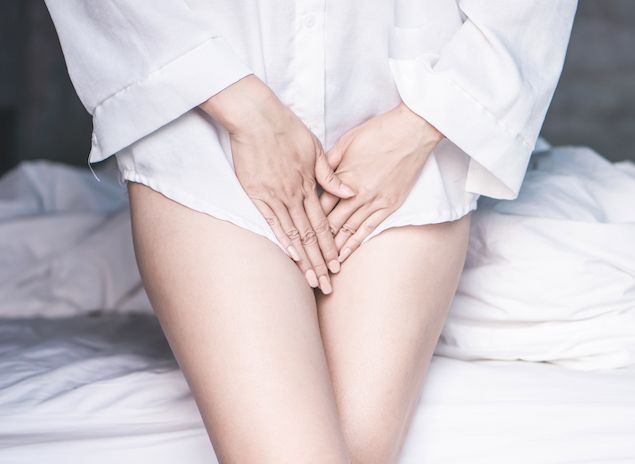 woman holding her crotch to illustrate having an itchy vulva