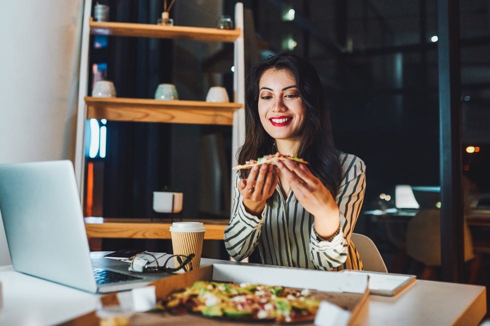 long distance valentines day - woman with pizza and computer 