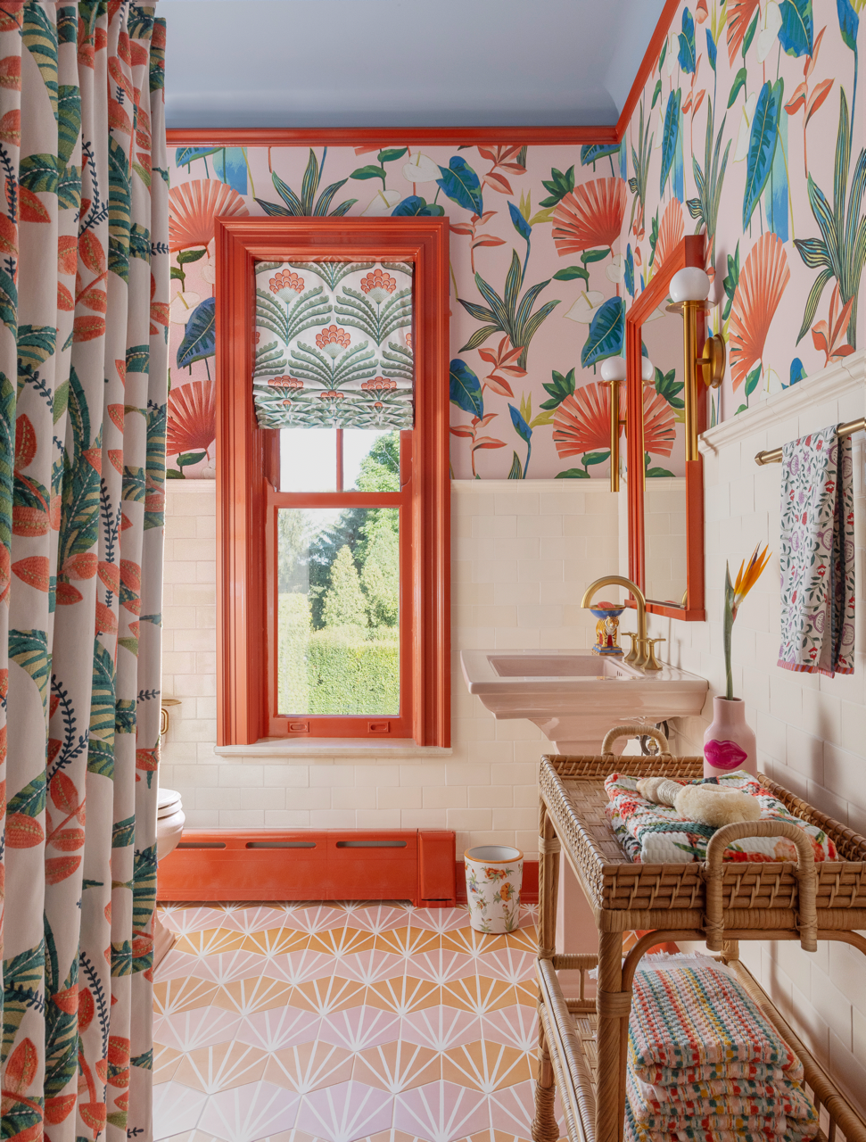 brightly decorated bathroom featuring floral wallpaper and a colorful shower curtain