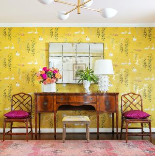 console and chairs in front of chinoiserie wallpaper