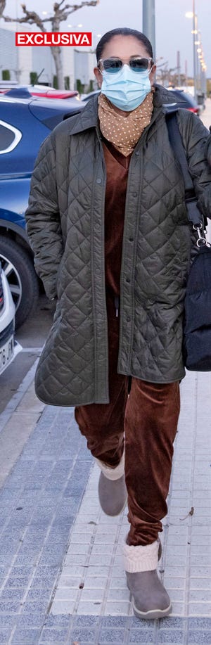 la cantante, con mascarilla, gafas de sol y un panuelo de topos, sale de un hospital