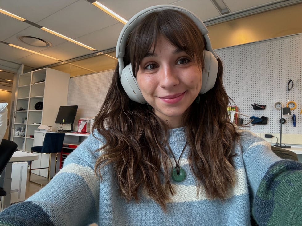 isabella wearing sony xm5 headphones in the office