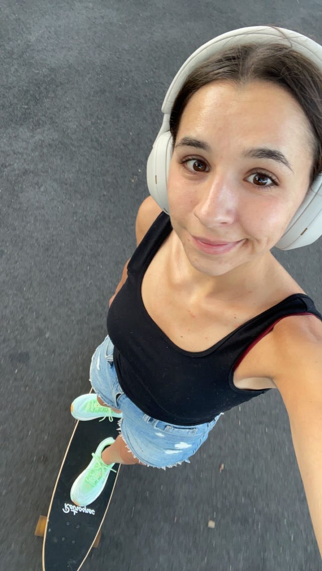 isabella cavallo wearing the sony xm5 headphones while she skateboards