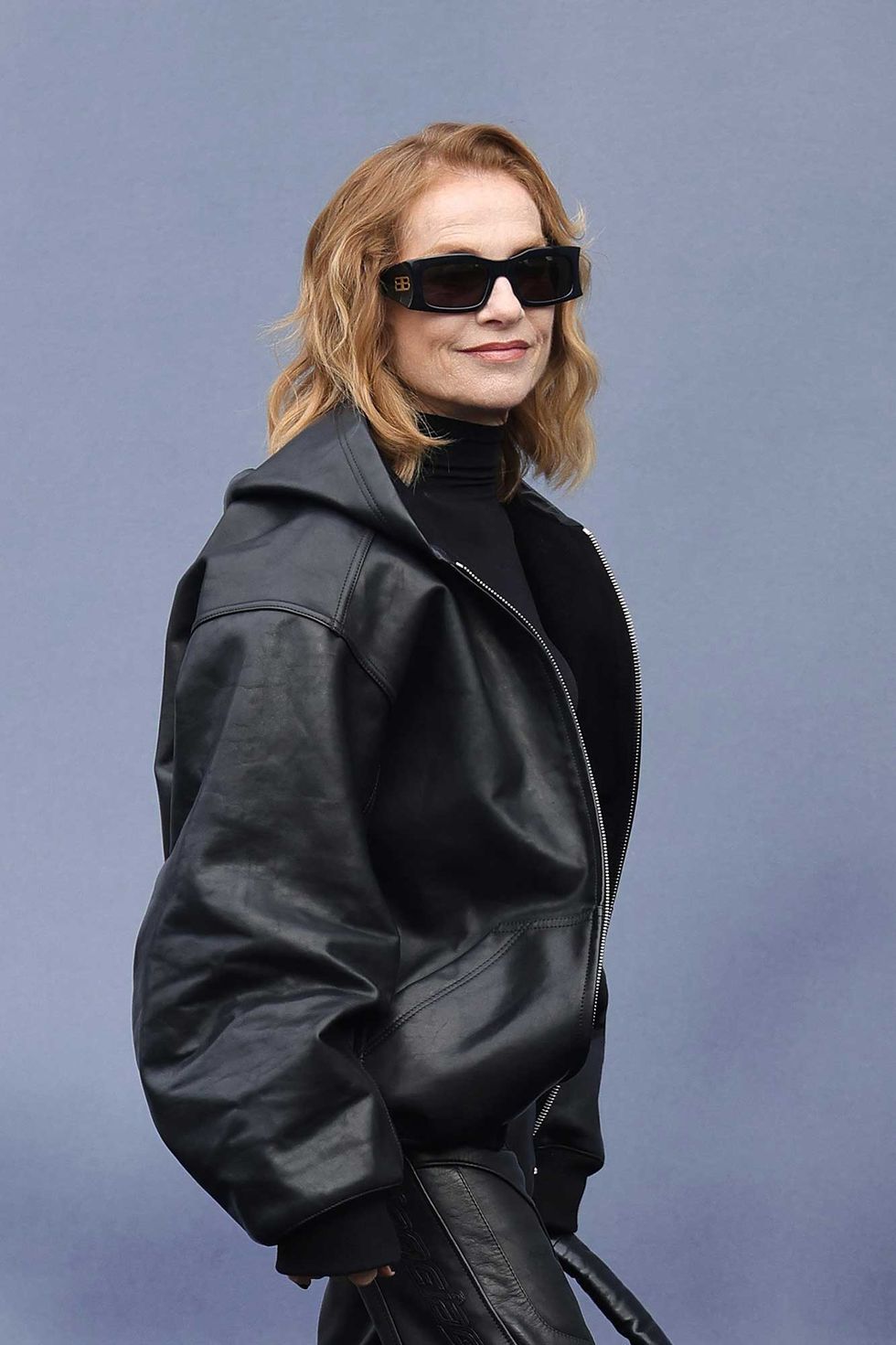 a person wearing sunglasses and a leather jacket