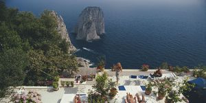 sunbathers lounge on the white painted terrace of il canille, built into the rocks of pizzolungo overlooking the waters off the coast of the island of capri, italy, in august 1980 il canille is the villa owned by italian tailor and fashion designer umberto tirelli 1928 1992 photo by slim aaronsgetty images