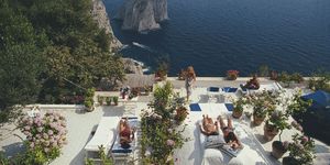 sunbathers lounge on the white painted terrace of il canille, built into the rocks of pizzolungo overlooking the waters off the coast of the island of capri, italy, in august 1980 il canille is the villa owned by italian tailor and fashion designer umberto tirelli 1928 1992 photo by slim aaronsgetty images