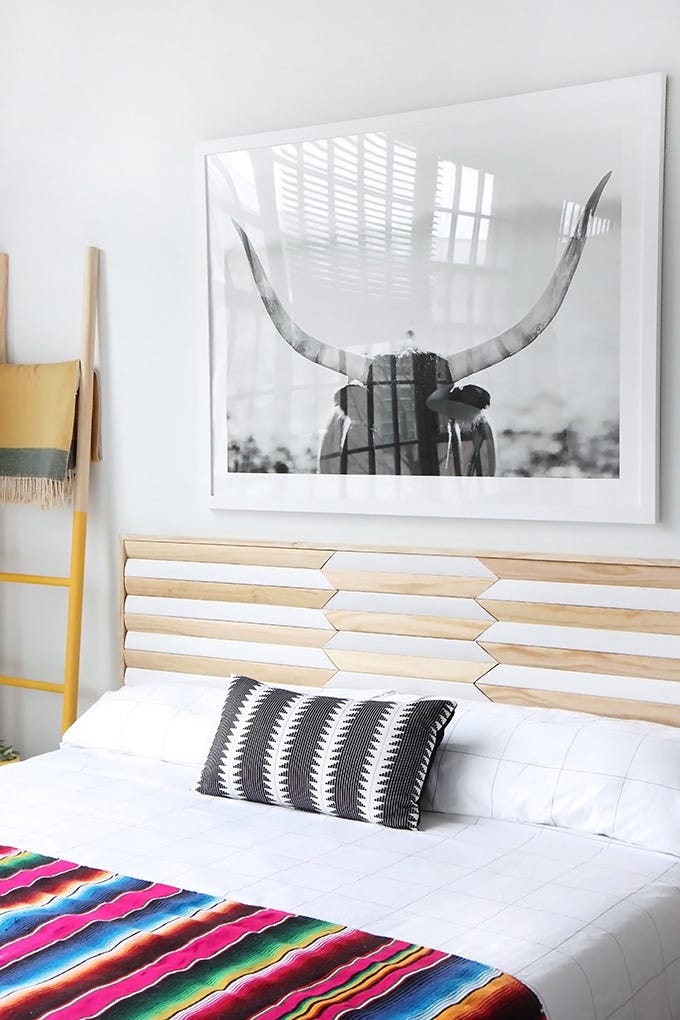 white bedroom with diyed geometric wood headboard