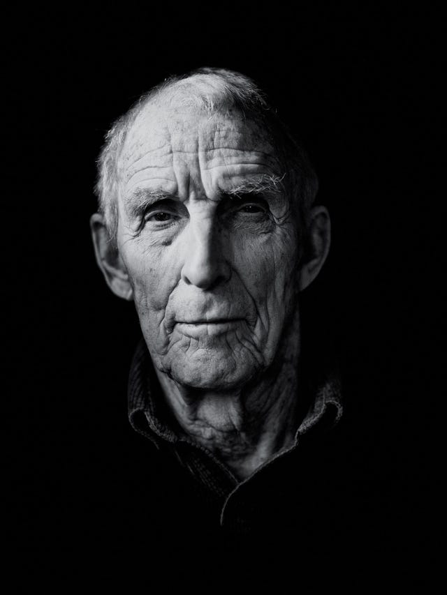 black and white close up portrait of peter matthiessen in his later years, looking directly into the camera, deep lines across his face.