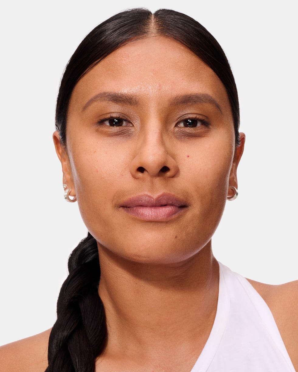 a person with a braided hairstyle wearing a white garment