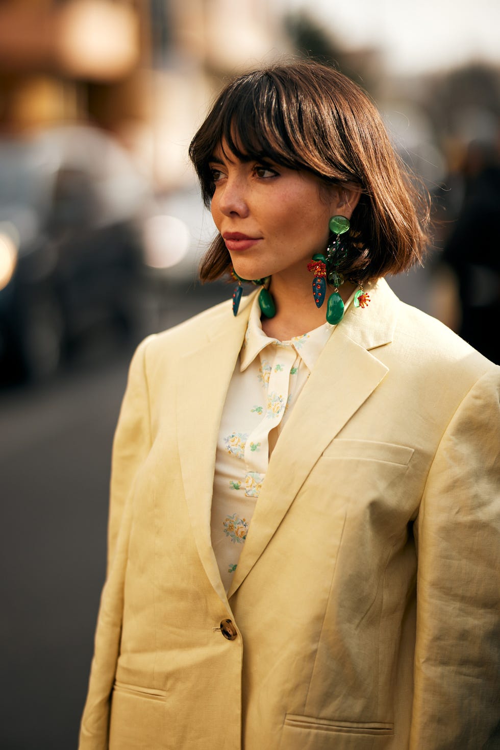 Person in a light yellow blazer and a floral blouse Italian Bob dressed