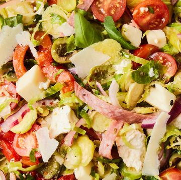 brussels sprouts salad with olives, tomatoes, red onions, shaved parmesan, and salami