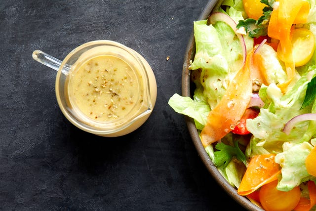 italian dressing next to a dressing topped salad italian dressing next to a dressing topped salad