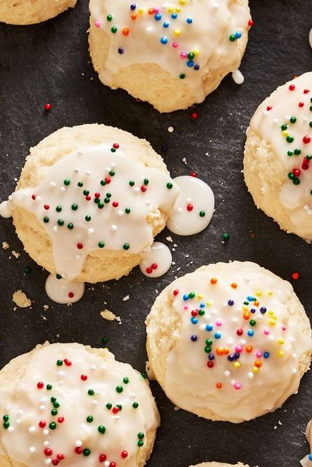 italian ricotta cookies topped with icing glaze and non pareil sprinkles