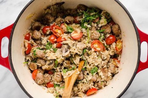 one pot sausage veggie rice with wooden spoon