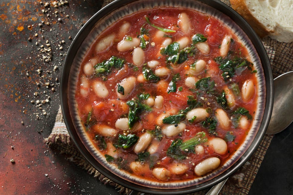 italian white bean, tortellini soup with spinach and carrots in a tomato broth